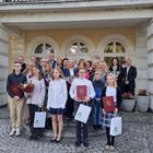 Fotografia nagrodzonych nauczycieli z okazji  Dnia Edukacji Narodowej oraz uczniów, którym przyznano stypendium im. Św. Jana Pawła II wykonane przed wejściem do budynku Rady Miasta Józefowa